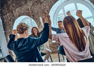 Young People Celebrating Recovery From Alcohol Addiction, Team Work Of Anonymous Addicts Club, Raised Hands Up Together. Selective Focus