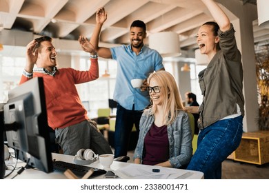 Young people celebrating a successful job at the startup company office