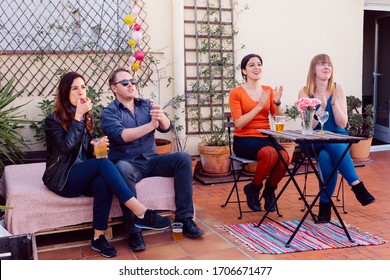 Young People Cheering On A Live Concert At A Rooftop. Intimate Concert Outdoors In Springtime. Leisure And Music Concept. Friends Having Fun At A Music Concert.