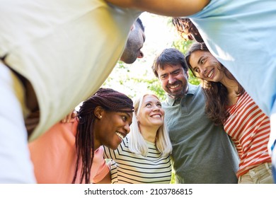 Young People In A Circle Put Their Heads Together For Friendship And Integration