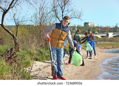 Young People Cleaning Beach Area. Volunteering Concept