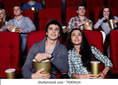 Young People Are Closely Watching A Movie At The Cinema