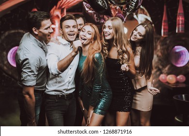 Young People. Dance Club. Sing. Men. White Shirt. Microphone. Trendy Modern Nightclub. Party Maker. Birthday. Karaoke Club. Celebration. Holidays Concept. Dancing People. Great Mood.