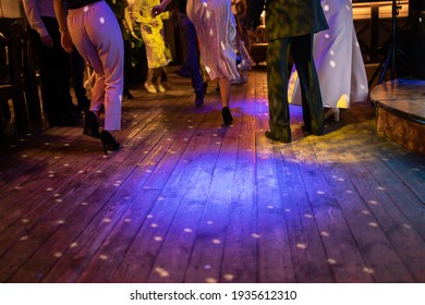 Young People Dancing During The Wedding Party. Legs Dancing On Disco.