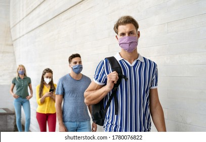 Young People From Different Cultures And Race Waiting In Queue Outside Shop Market While Keeping Social Distance - Corona Virus Spread Prevention Concept