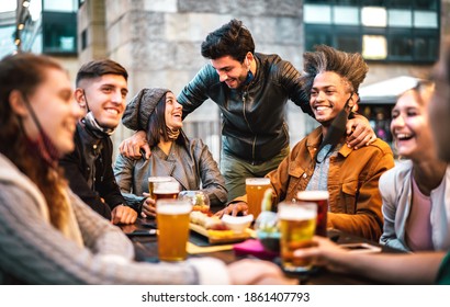 Young People Drinking Beer With Open Face Mask - New Normal Lifestyle Concept With Milenial Having Fun Together Talking On Happy Hour At Outside Brewery Bar - Warm Filter With Focus On Central Guy