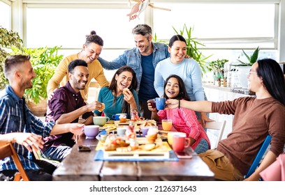 Young people drinking and eating at coffee bar - Friends talking and having fun together at fancy cafeteria - Friendship life style concept with happy guys and girls at restaurant cafe - Bright filter - Powered by Shutterstock