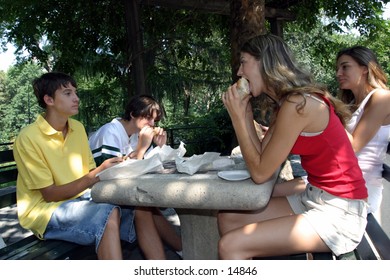 young people eating on outdoor table