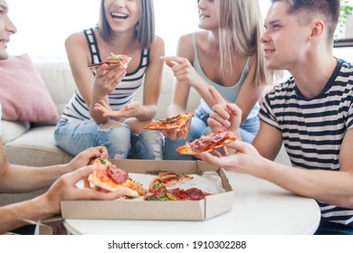 Young People Eating Pizza. Group Of Friends Having Lunch Indoors. Funny Friends Together.