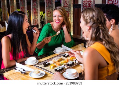 Young People Eating Sushi In Asian Restaurant