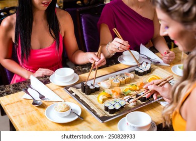 Young People Eating Sushi In Asian Restaurant
