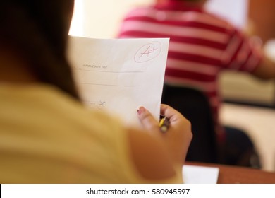 Young People And Education. Group Of Hispanic Students In Class At School During Lesson. Good Grade For Smart Student On Test