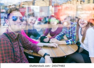 Young People Enjoying And Having Fun (image Taken Mostly Behind Glass Reflection For Desired Look)