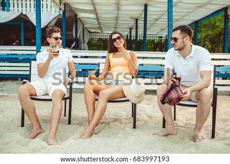 Similar – Young friends holding woman on top of surfboard