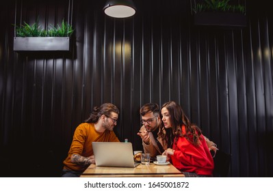 Young People at Fast Food Restaurant looking at Laptop	 - Shutterstock ID 1645001872