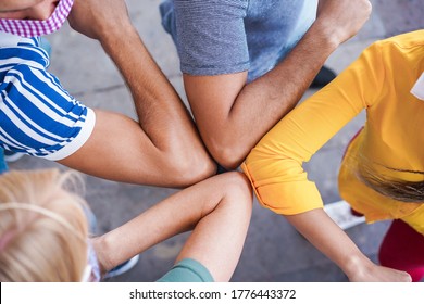 Young people friends bump their elbows instead of greeting with a hug - Avoid the spread of coronavirus, social distance and friendship concept  - Powered by Shutterstock