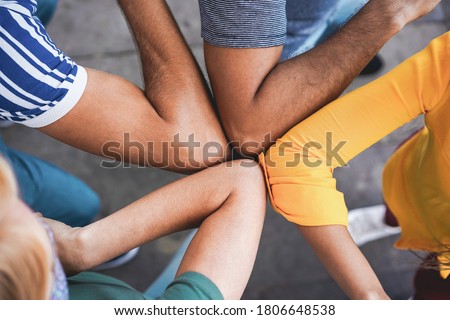 Young people friends bump their elbows instead of greeting with a hug - Avoid the spread of coronavirus, social distance and friendship concept - Main focus on left bottom arm