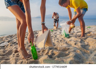 Young People Friends Picking Up Trash And Garbage On Tropical Beach Saving Planet And Ecology In Indonesia, Thailand And Philippines