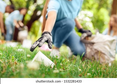 Young People Girls Volunteers Outdoors Helping Nature Girl Wearing Gloves Close-up Picking Litter Plastic Cup Blurred Background