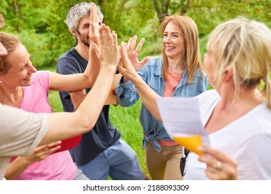 Young people give the high five for team spirit and motivation in the team building workshop - Powered by Shutterstock