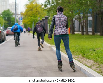 Young People Go Outdoors To Have Different Sports Activities. Extreme Sports Is Very Popular Among Youth. Backs / Rear View. Coronavirus Pandemic Is Over In Moscow