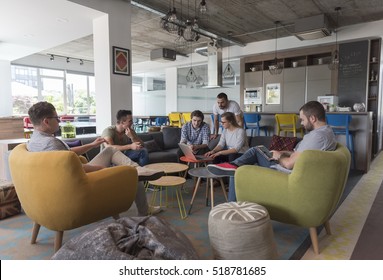 young people group in modern office have team meeting and brainstorming while working on laptop and drinking coffee - Shutterstock ID 518781685