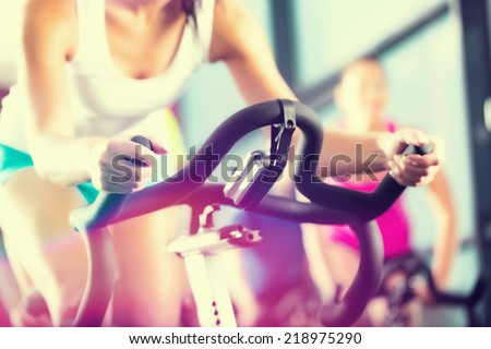 Young People - group of women and men - doing sport in the gym for fitness