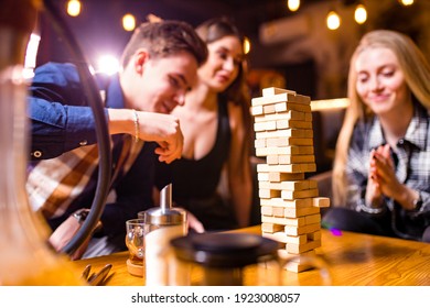 Young People Have Fun Playing Board Games At A Table