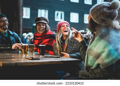 Young people having fun drinking beer at pub restaurant - Soft focus on center girl face - Powered by Shutterstock