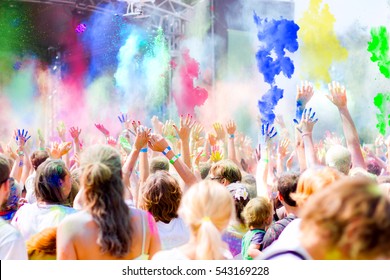 Young People Having Fun During Holi Fest Throwing Colorful Powder In The Air