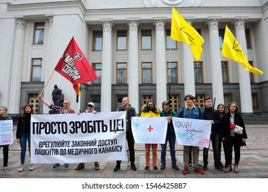 Young People Holding Broadsheet Demanding Legalization Of Medical Marijuana, Building Of Ukrainian Parliament On A Background. Cannabis March. October 26, 2019. Kiev, Ukraine 