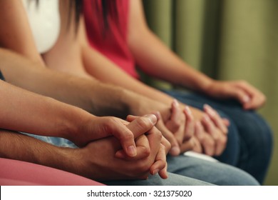 Young people holding hands close up