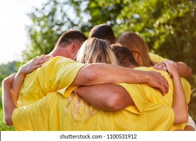 Young People Hug Each Other In A Teambuilding Exercise Outdoors In Nature