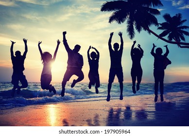 Young People Jumping With Excitement On A Beach