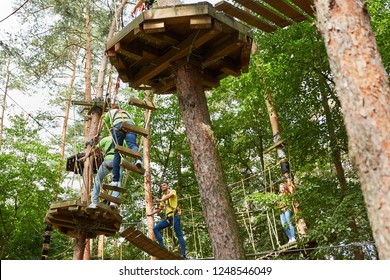 Young People Learn To Climb In The High Ropes Course At A Team Building Event