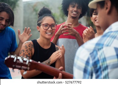 Young People Listening To A Concert Of A Guitar Player