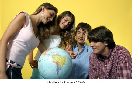 young people looking at globe