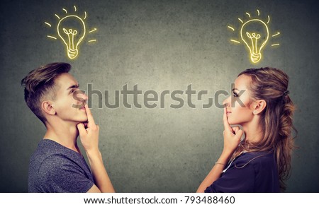 Young people man and woman posing together enlightened with idea looking positive. 