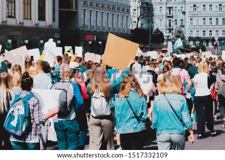 Young people marching on the street protest. Take a part in a march. Rally. Movement. Protest in the city