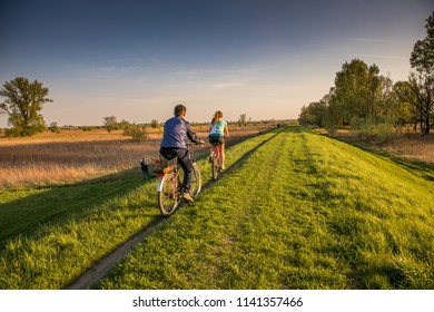 Young people on a bicycle during a bicycle tour, embankment  over the Vistula river bank near Karczew and Otwock - Powered by Shutterstock