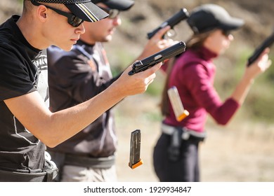 Young people on tactical gun training classes. Shooting and Weapons. Outdoor Shooting Range