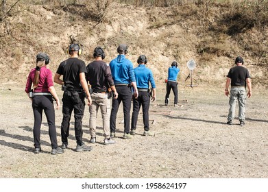 Young People On Tactical Gun Training Classes. Shooting And Weapons. Outdoor Shooting Range