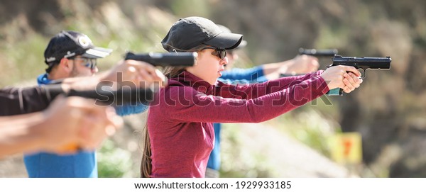 Young people on tactical gun
training classes. Shooting and Weapons. Outdoor Shooting
Range