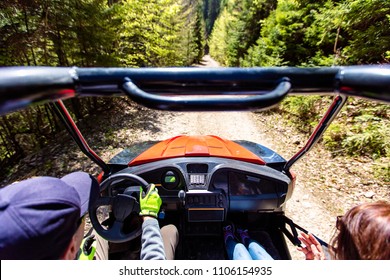 Young People On UTV Vehicles On A Countryside Trail. View From A UTV Vehicle With Man Driving An UTV On A Sunny Day.