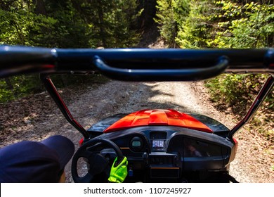 Young People On UTV Vehicles On A Countryside Trail. View From A UTV Vehicle With Man Driving An UTV On A Sunny Day.