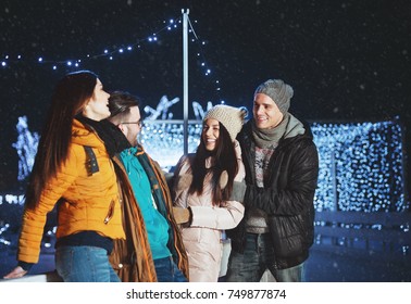 Young People Outdoors Having Fun On A Winter Evening 