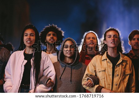 Young people participating in a massive rally. Youngsters protesting together for a change.