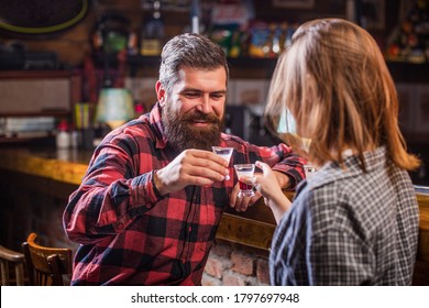 Young people at the party drink alcohol. Woman alcoholic beverage in bar. Young woman has problems with alcohol. Female male alcoholism. Young man drinking alcohol.