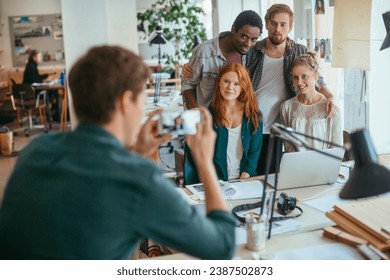 Young people posing for group photo in modern startup office - Powered by Shutterstock