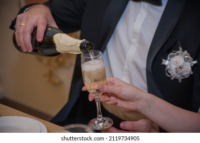 Young People Pour Champagne To Each Other At A Gala Evening